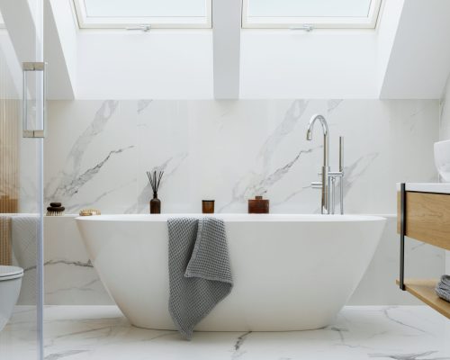 Stylish bathroom interior design with marble panels. Bathtub, towels and other personal bathroom accessories. Modern glamour interior concept. Roof window. Template.